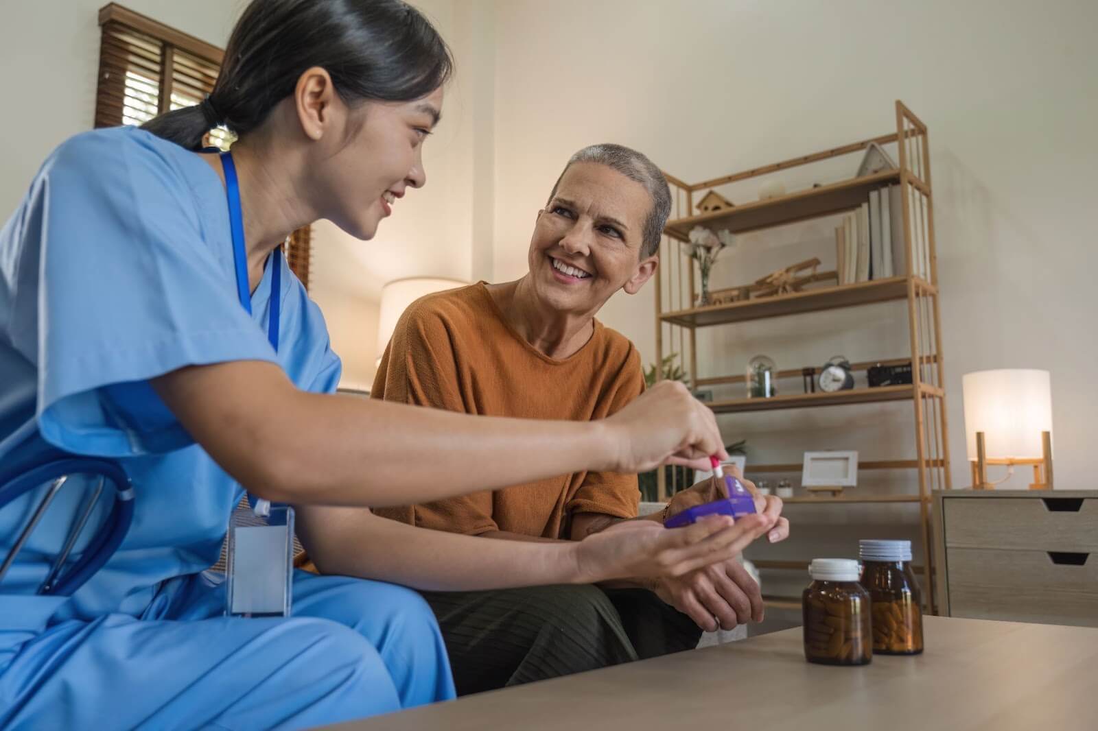 A nurse assisting a elderly woman with medication at home