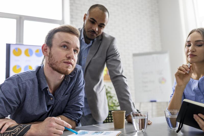 A group of coworkers considering different alternatives in an office setting.