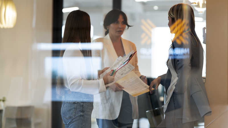 Franchisees reviewing the Franchise Disclosure Document together in a modern office setting.